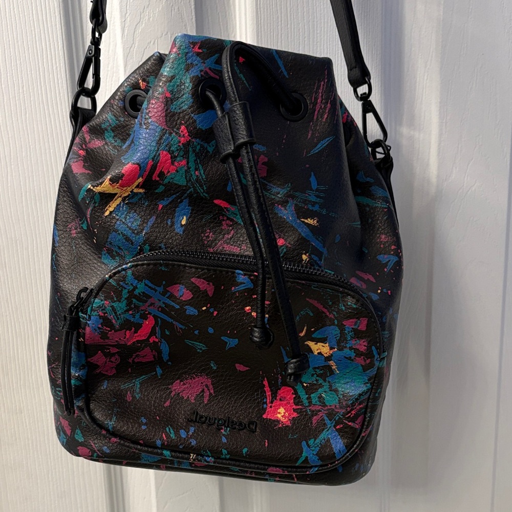 Desigual Spanish Designer paint splatter bucket bag with adjustable straps.